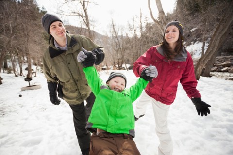 Front view of boy (4-5) with parents during stroll