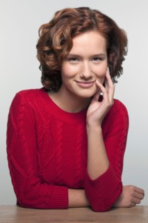 Studio shot portrait of young woman in red pullover