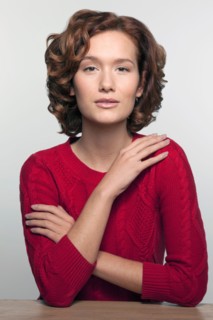 Studio shot portrait of young woman in red pullover