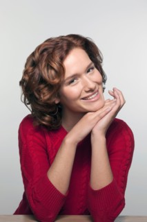 Studio shot portrait of young woman in red pullover