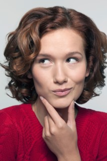 Studio shot portrait of young woman in red pullover