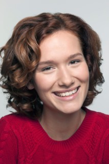 Studio shot portrait of young woman in red pullover