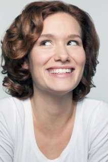 Studio shot portrait of young woman in white blouse