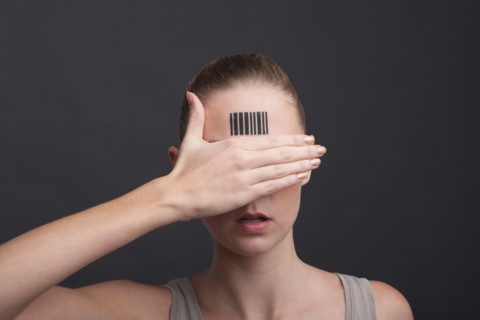 Studio portrait of woman with bar code on forehead
