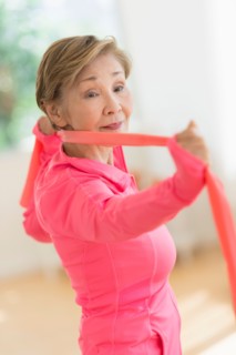 Senior woman exercising with exercise band.