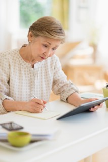 Senior woman using tablet pc at home.
