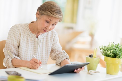 Senior woman using tablet pc at home.