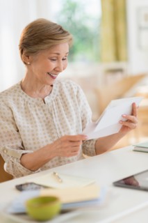 Senior woman reading letter.