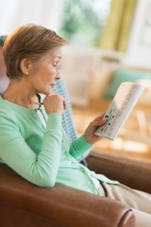 Senior woman doing crossword puzzle.