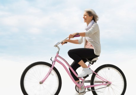 Senior woman riding bicycle.