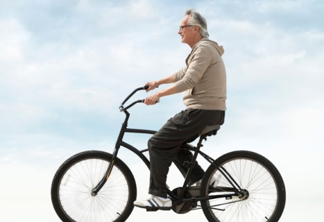 Senior man riding bicycle.