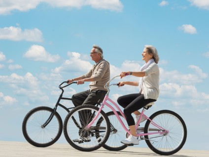 Senior couple riding bicycle.