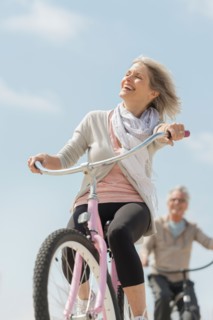 Senior couple riding bicycle.