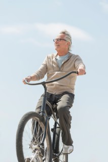 Senior man riding bicycle.