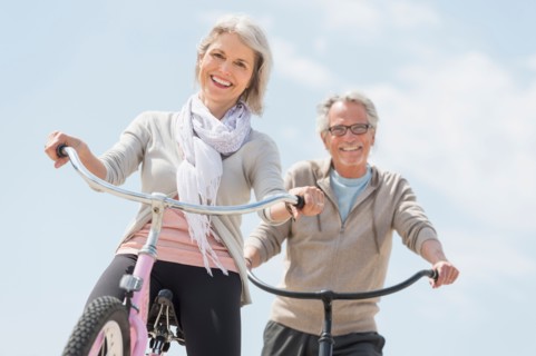 Senior couple riding bicycle.
