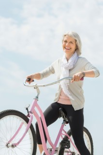 Senior woman riding bicycle.