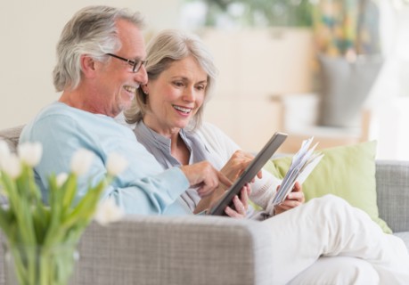 Senior couple paying bills via internet.