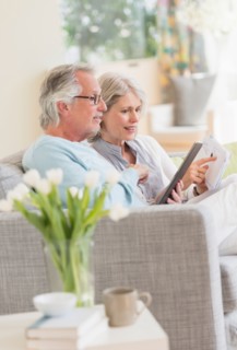 Senior couple paying bills via internet.