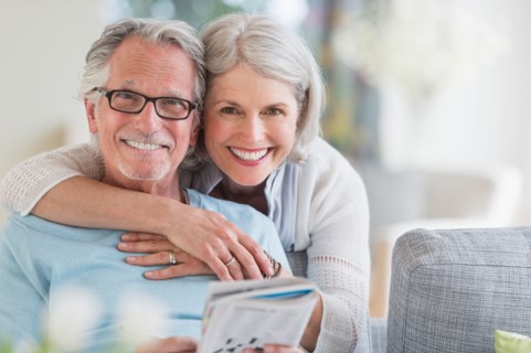 Senior woman embracing senior man.