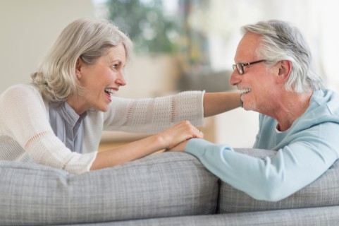 Senior couple sitting on sofa.