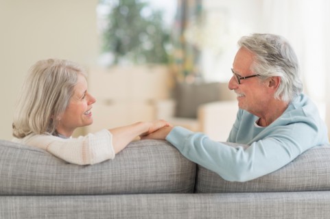 Senior couple sitting on sofa.