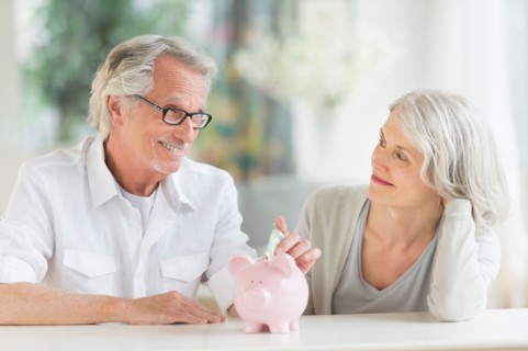 Senior couple with piggybank.