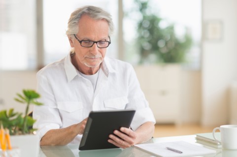 Senior man using digital tablet.