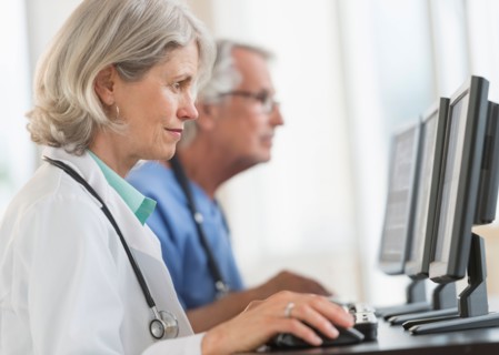 Female and male doctors working at computers.