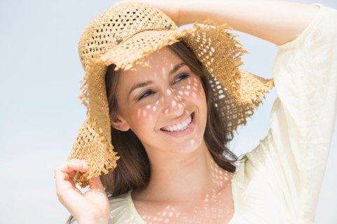 Portrait of beautiful young woman in sun hut.