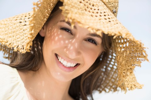 Portrait of beautiful young woman in sun hut.