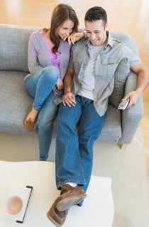 Young couple relaxing on sofa.