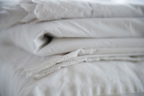 Close up of folded white sheets, studio shot