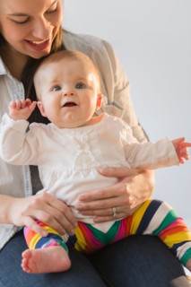 Mother playing with baby daughter (6-11 months)