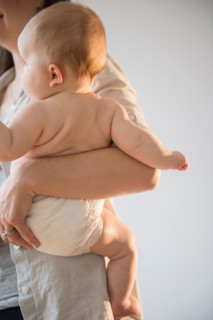 Mother holding baby girl (6-11 months)