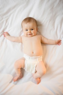 Portrait of baby girl (6-11 months) lying down