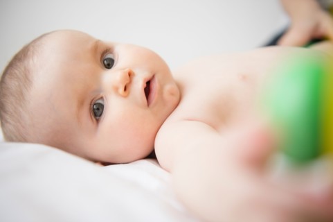 Portrait of baby girl (6-11 months) lying down