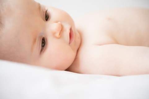 Portrait of baby girl (6-11 months) lying down