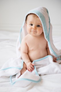 Portrait of baby girl (6-11 months) in poncho towel