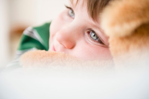 Portrait of boy (4-5) snuggling to teddy bear