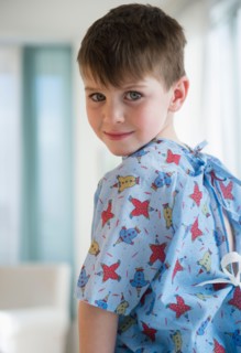 Portrait of boy (4-5) in surgical gown