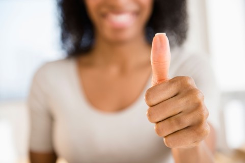 Woman making thumbs up gesture