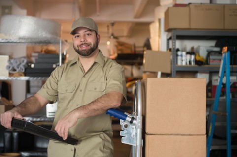 Portrait of delivery man in warehouse