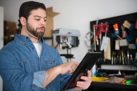 Portrait of man using digital tablet in workshop