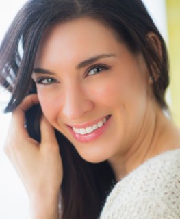 Portrait of woman with hand in hair, Looking at camera