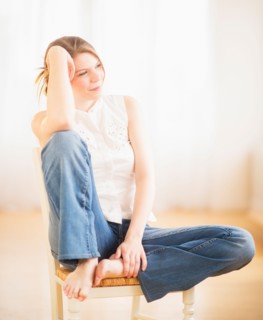 Young cheerful woman sitting on chair