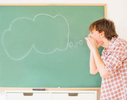 Teenage boy (14-15) having fun in classroom