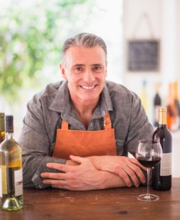 Portrait of cheerful wine store owner