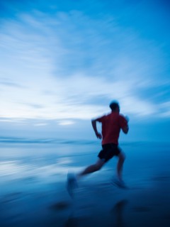 Man running along beach