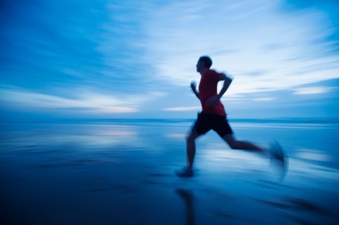 Man running along beach