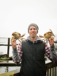 Portrait of man showing crabs